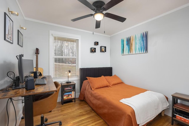 bedroom featuring light wood-type flooring, ceiling fan, and crown molding