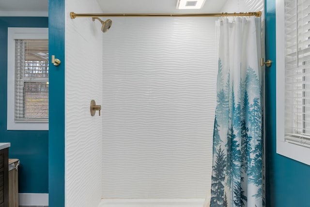 bathroom featuring crown molding, walk in shower, and vanity