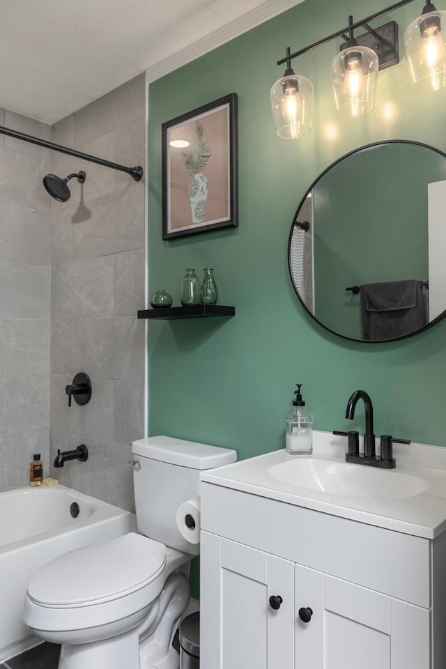 full bathroom with vanity, toilet, and tiled shower / bath