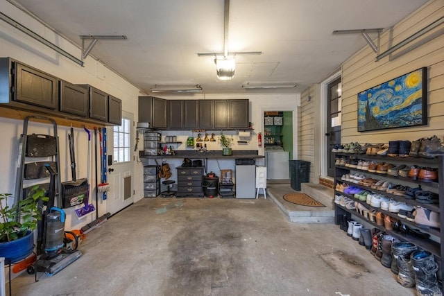 garage with wooden walls and a garage door opener