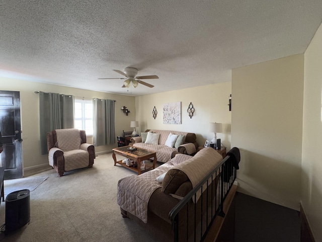 living room with ceiling fan, carpet flooring, and a textured ceiling