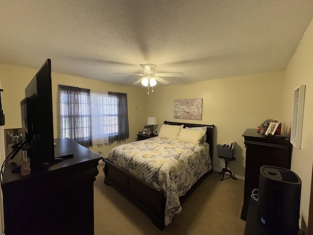 carpeted bedroom featuring a textured ceiling and ceiling fan