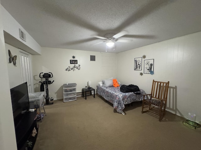 bedroom featuring ceiling fan, a textured ceiling, and carpet