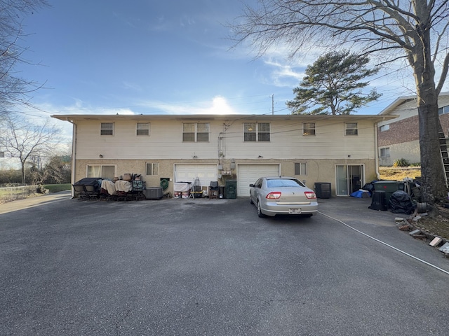 back of house featuring a garage