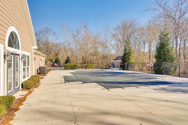 view of pool featuring central AC and a patio