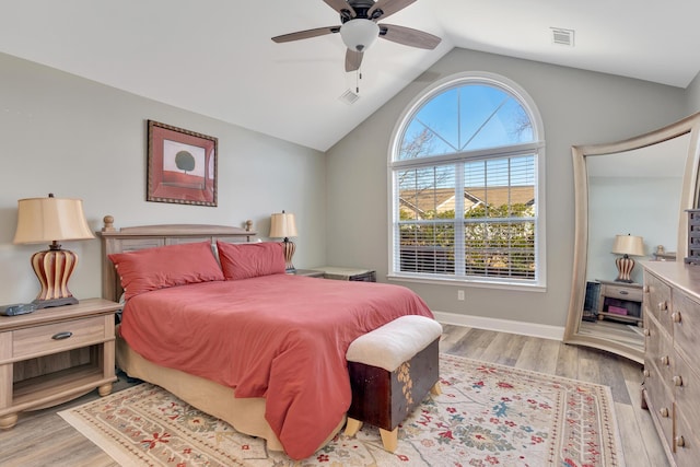 bedroom with vaulted ceiling, light hardwood / wood-style floors, and ceiling fan