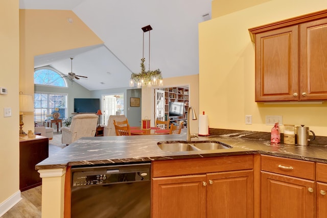 kitchen featuring lofted ceiling, sink, light hardwood / wood-style flooring, black dishwasher, and ceiling fan with notable chandelier