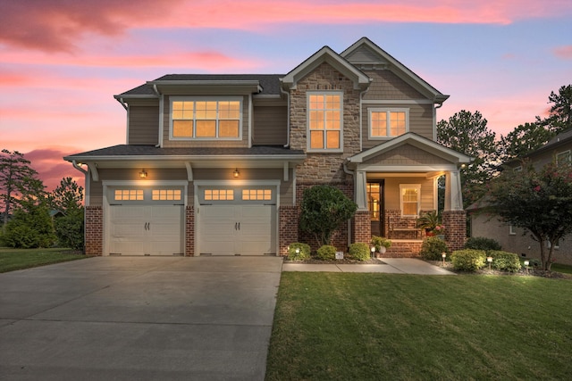 craftsman inspired home with a garage and a lawn