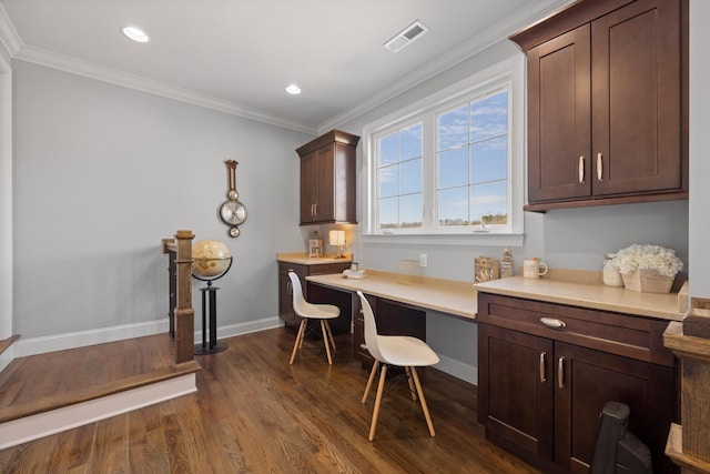 office with ornamental molding, dark hardwood / wood-style floors, and built in desk