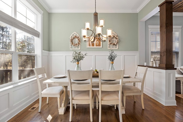 dining space featuring ornamental molding, dark hardwood / wood-style floors, and a notable chandelier