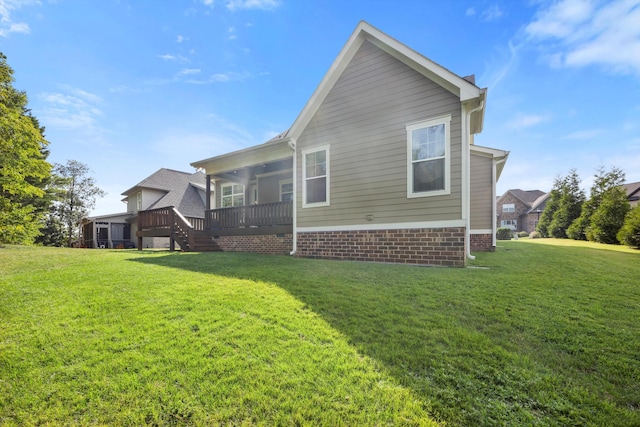 view of side of property with a yard and a deck