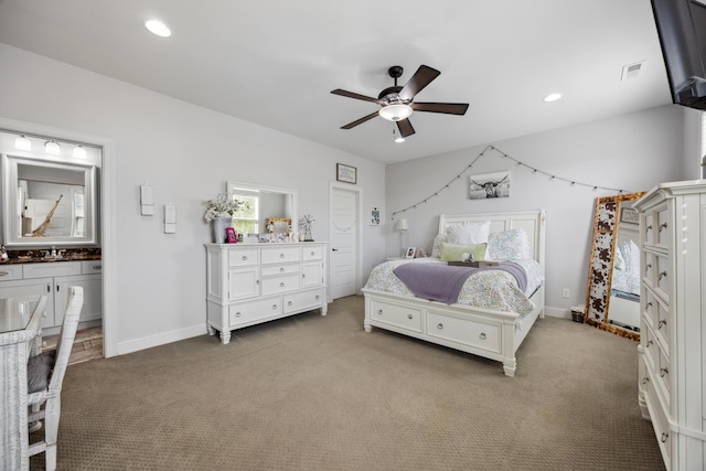 bedroom featuring ceiling fan, ensuite bathroom, sink, and carpet