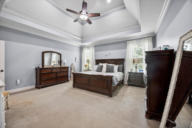 bedroom featuring ceiling fan, a raised ceiling, and multiple windows