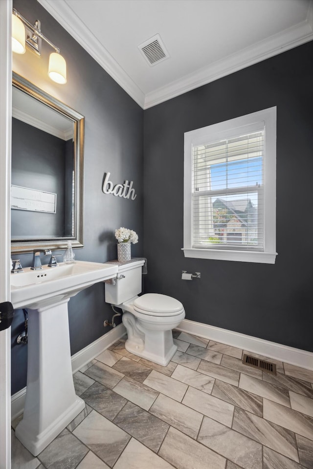 bathroom with crown molding and toilet