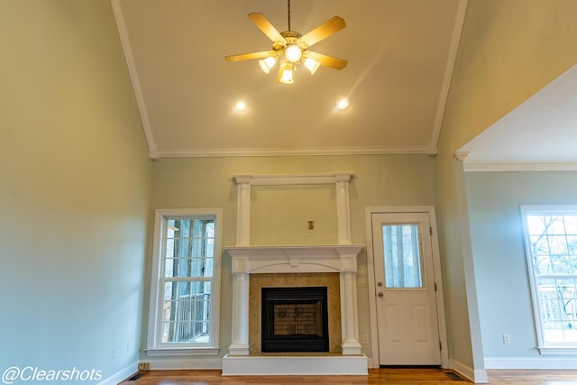 unfurnished living room with crown molding, ceiling fan, vaulted ceiling, and hardwood / wood-style floors