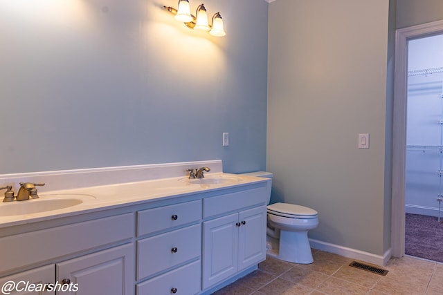 bathroom featuring tile patterned floors, vanity, and toilet