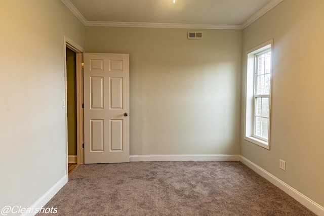 carpeted spare room featuring crown molding