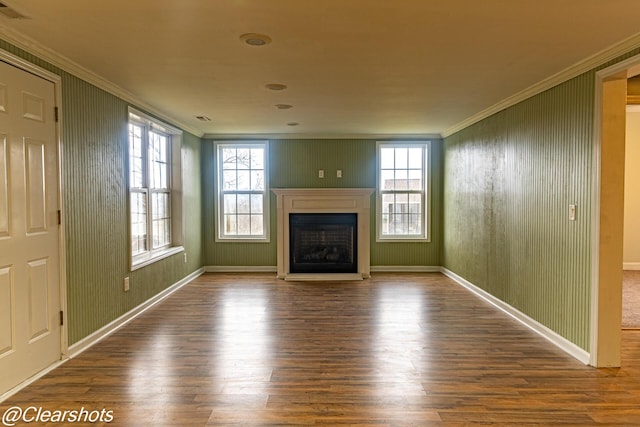 unfurnished living room featuring crown molding, plenty of natural light, and hardwood / wood-style floors