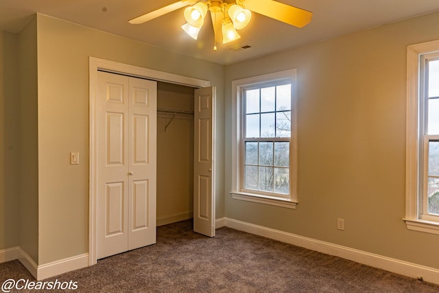 unfurnished bedroom with ceiling fan, carpet, and a closet