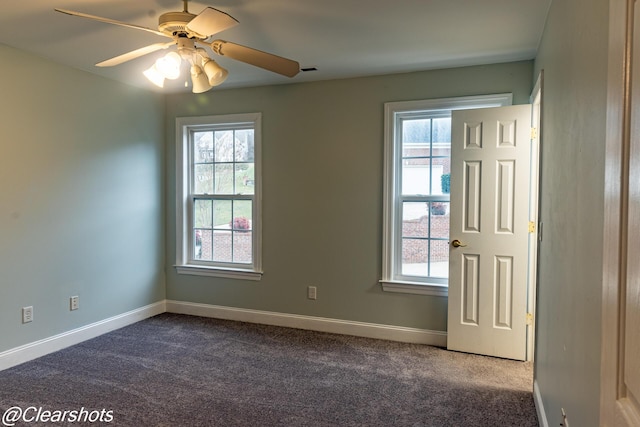 carpeted spare room featuring ceiling fan