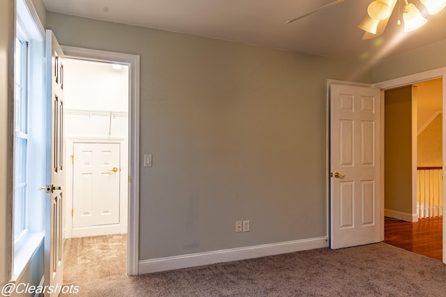 carpeted spare room featuring ceiling fan