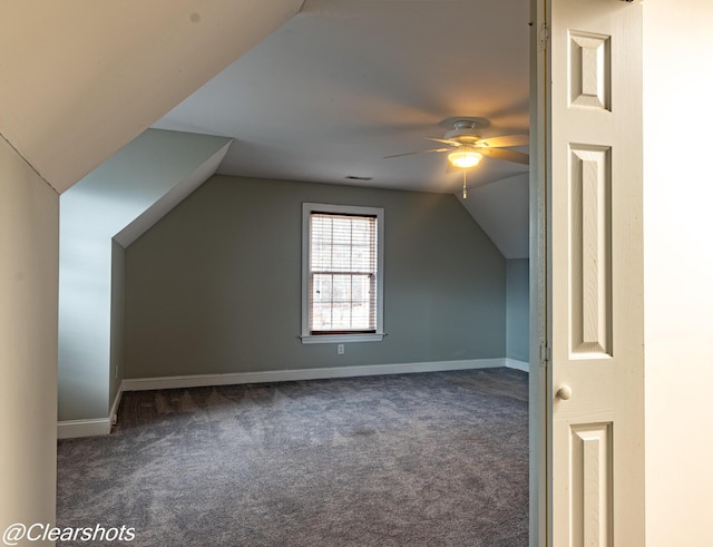 bonus room featuring dark carpet, vaulted ceiling, and ceiling fan