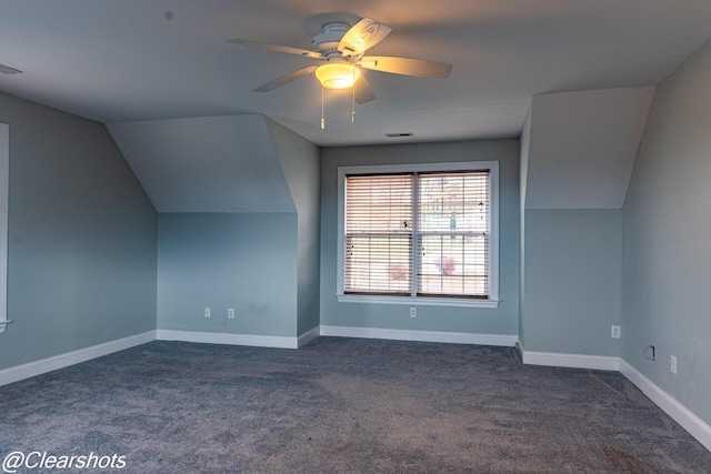 additional living space with vaulted ceiling, ceiling fan, and dark carpet