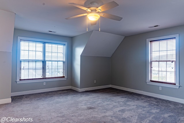 bonus room with vaulted ceiling, ceiling fan, and carpet flooring