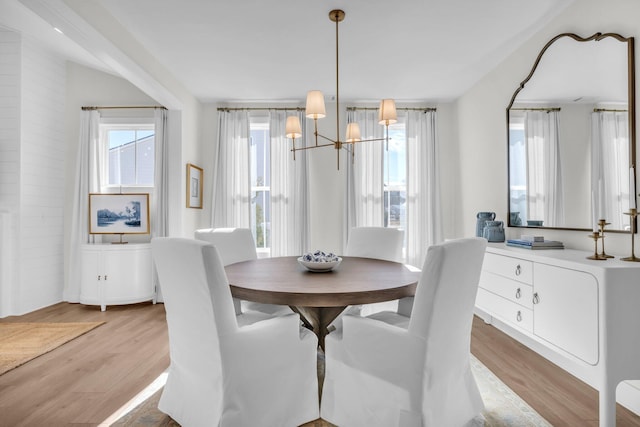 dining area featuring an inviting chandelier and light hardwood / wood-style flooring