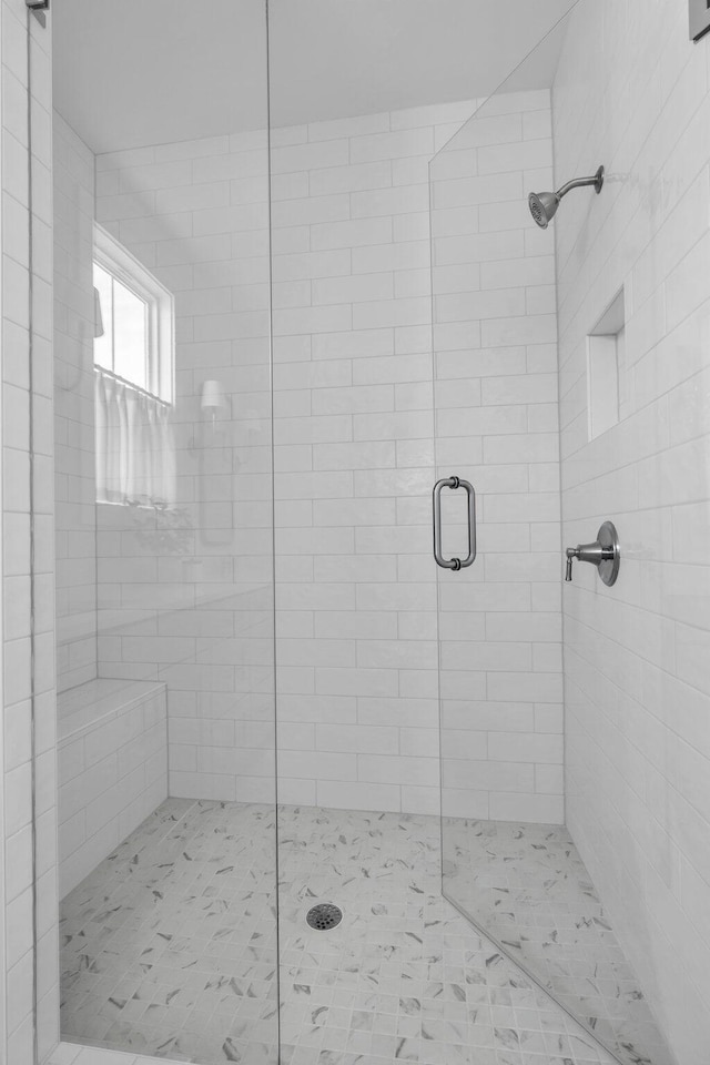 bathroom with a shower with shower door