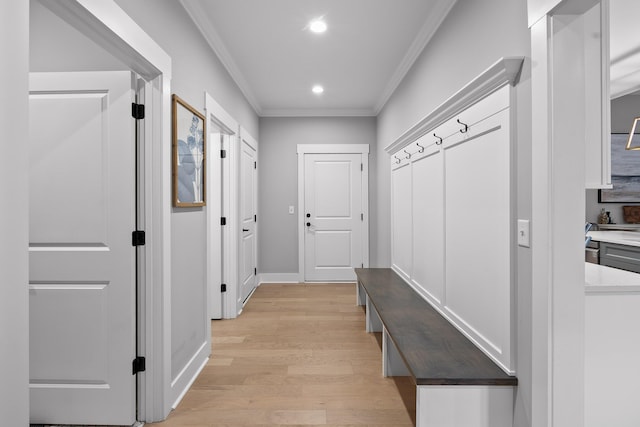 mudroom with light wood-type flooring and ornamental molding