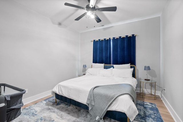 bedroom with hardwood / wood-style floors and ceiling fan