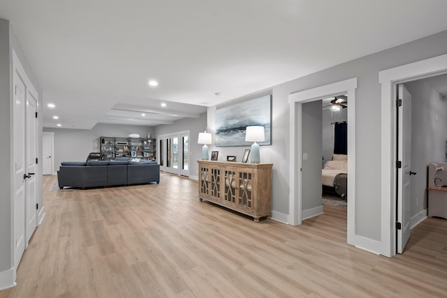 living room featuring ceiling fan and light hardwood / wood-style flooring