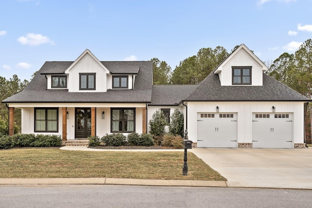 modern inspired farmhouse with a garage and a front lawn