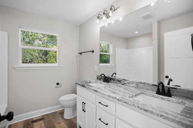 bathroom featuring hardwood / wood-style floors, toilet, and vanity