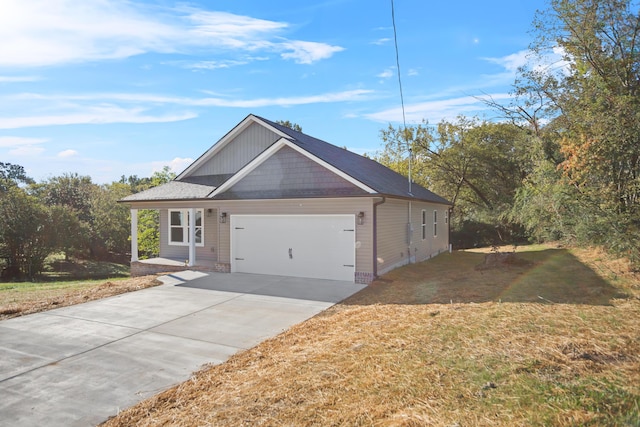 view of front of property with a front yard and a garage