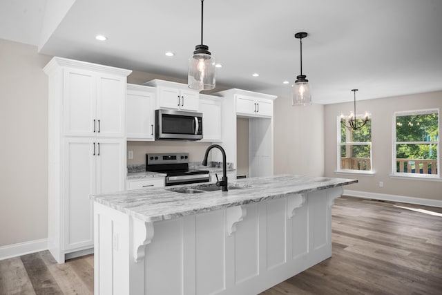 kitchen featuring white cabinetry, a kitchen island with sink, and appliances with stainless steel finishes