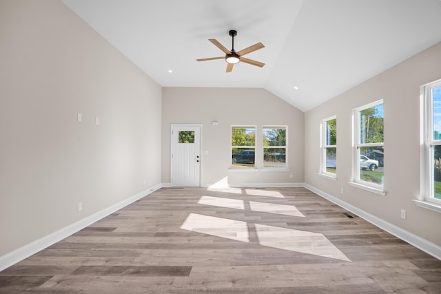 spare room with ceiling fan, light hardwood / wood-style floors, and lofted ceiling