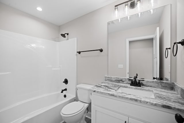 full bathroom featuring toilet, vanity, and  shower combination