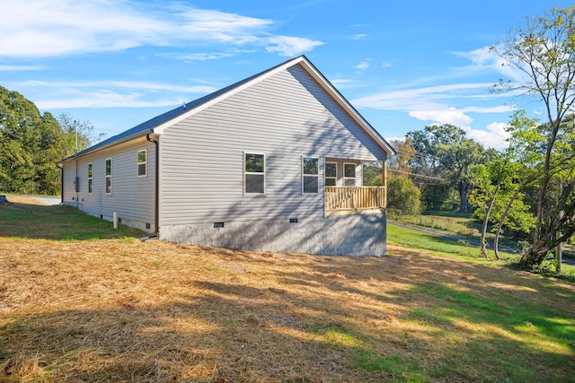 view of side of home with a yard