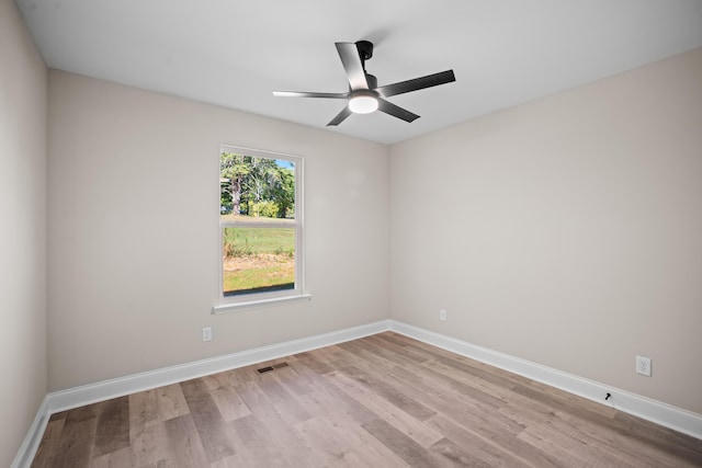 unfurnished room with light wood-type flooring and ceiling fan