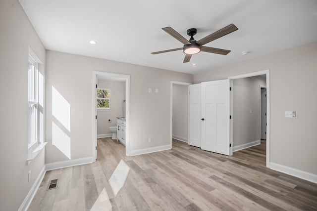 unfurnished bedroom with light hardwood / wood-style flooring, connected bathroom, and ceiling fan