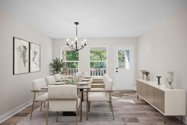 dining area featuring hardwood / wood-style floors and a chandelier