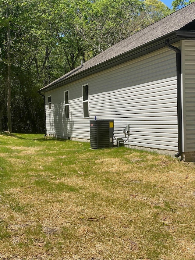 exterior space with a yard and cooling unit