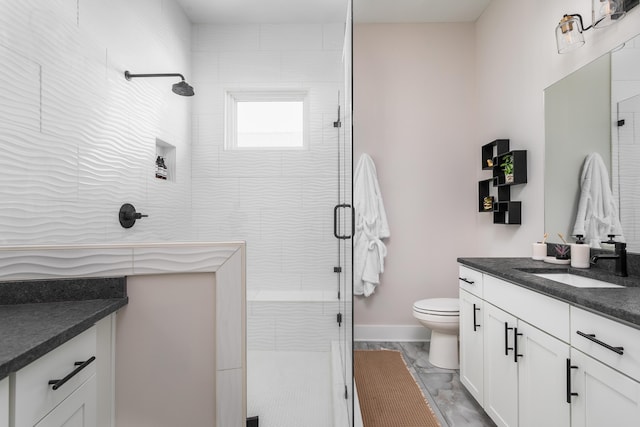 bathroom with an enclosed shower, vanity, and toilet