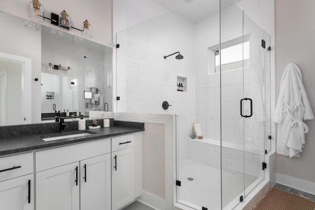 bathroom with vanity and a shower with door