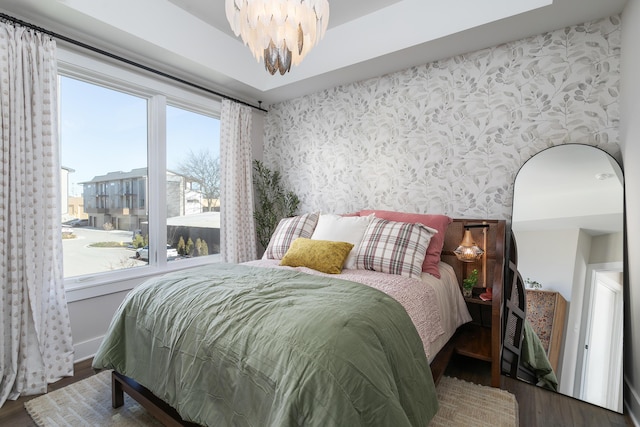 bedroom with dark wood-type flooring and a chandelier