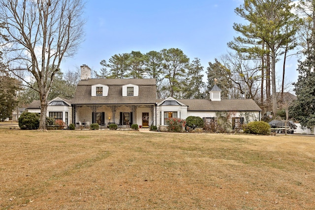 cape cod house with covered porch and a front lawn