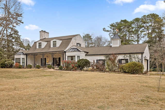 cape cod house with covered porch and a front yard