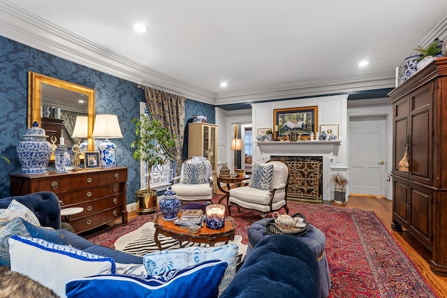 living room featuring hardwood / wood-style flooring, crown molding, and a fireplace